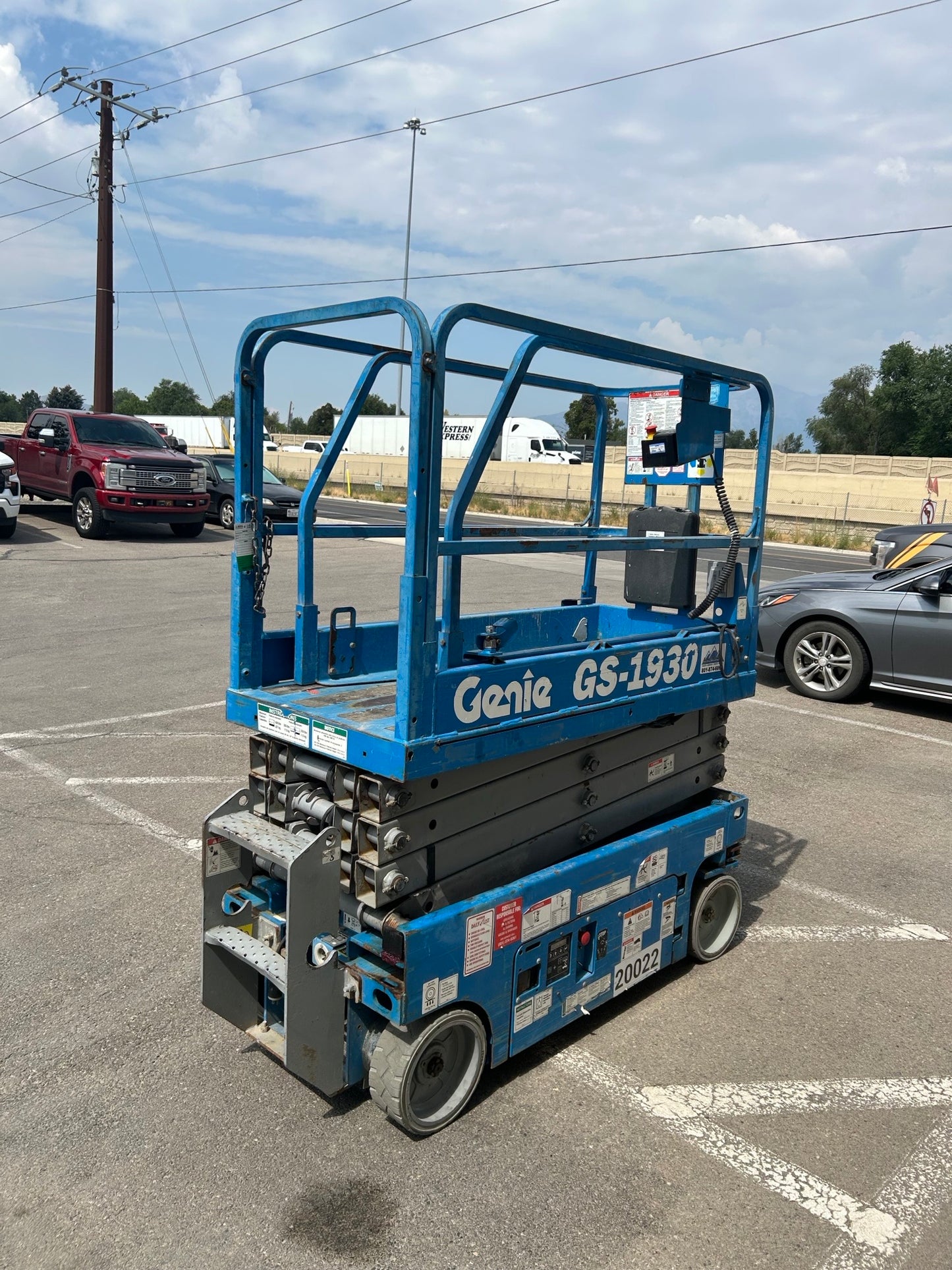 Genie GS-1930 26' electric slab scissor lift tire and wheel for narrow indoor rental access.