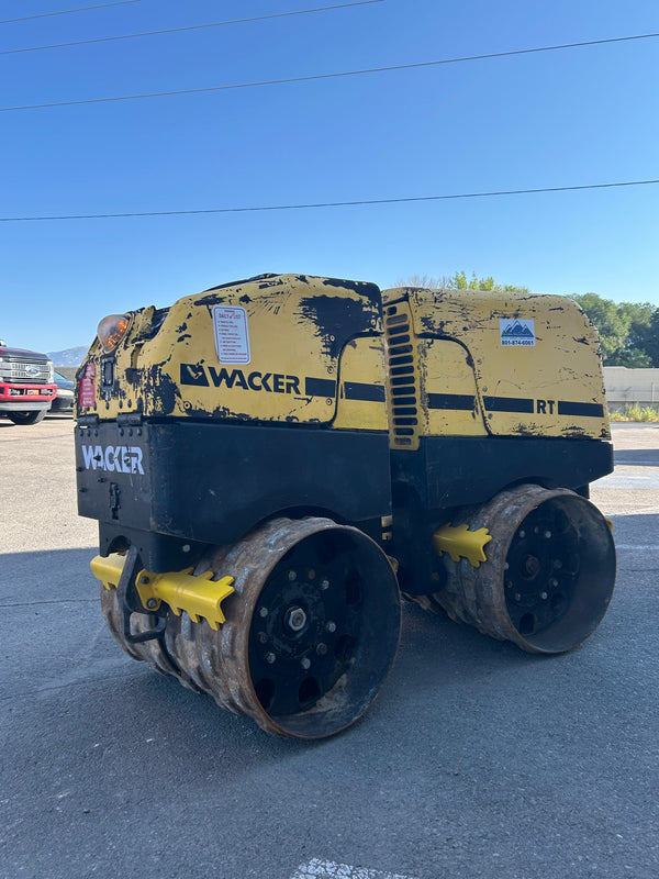 Remote control double drum trench roller heavy equipment rental for uniform soil compaction.