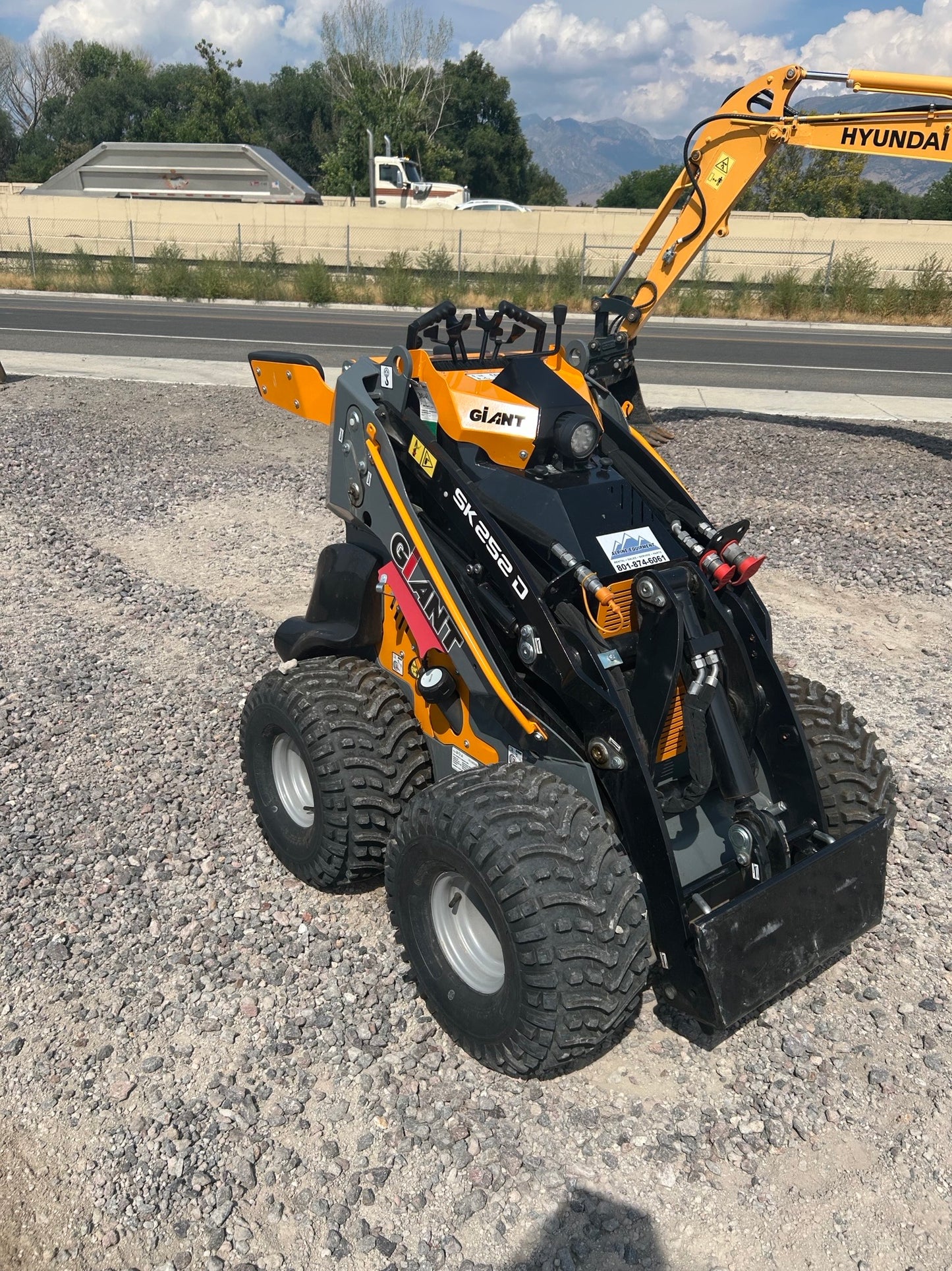 A wheeled skid steer machine features an automotive wheel system and an 1800 lb operating capacity.