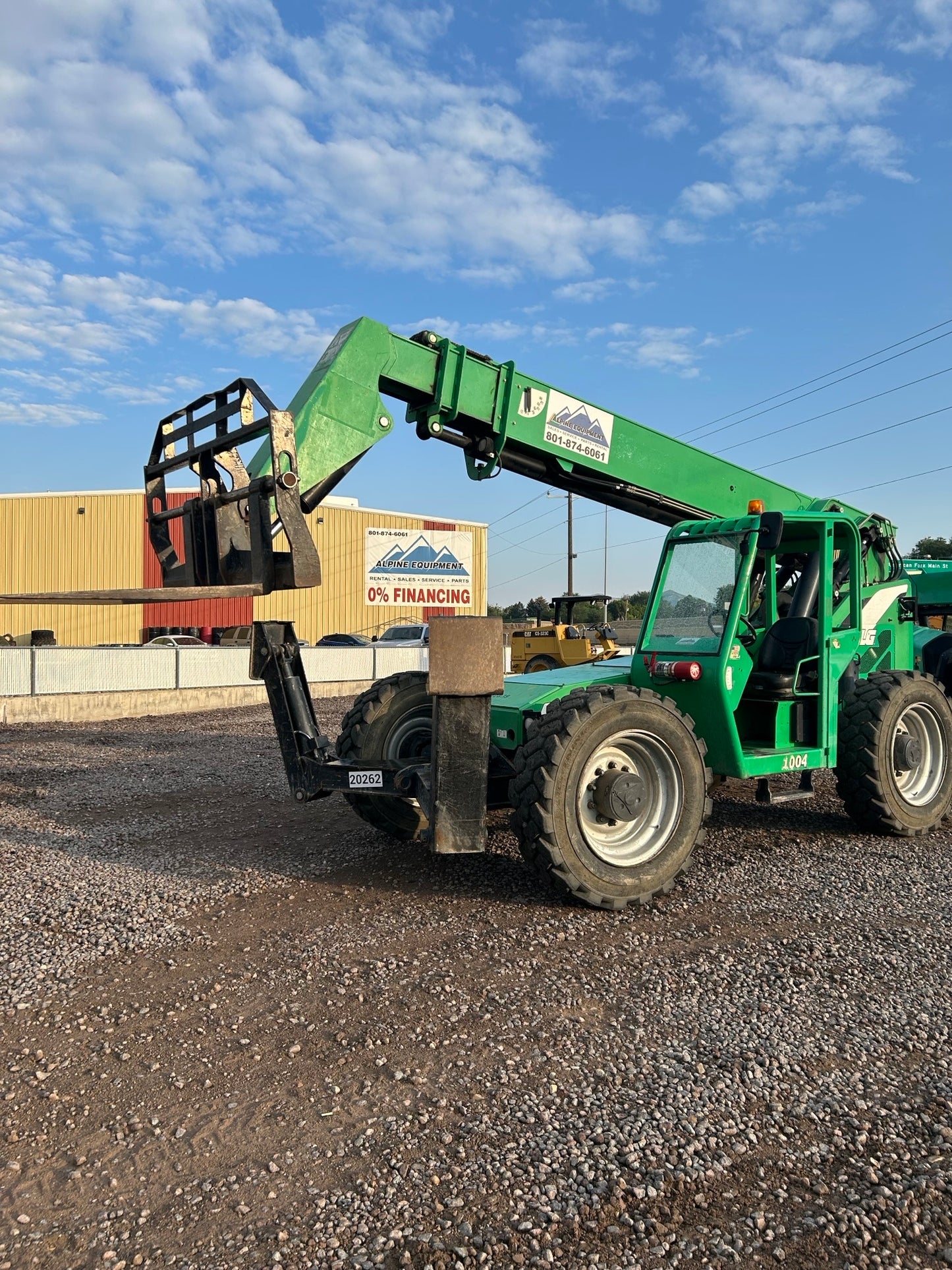 10K REACH 42' telehandler forklift showing its heavy-duty automotive wheel system and agricultural machinery.