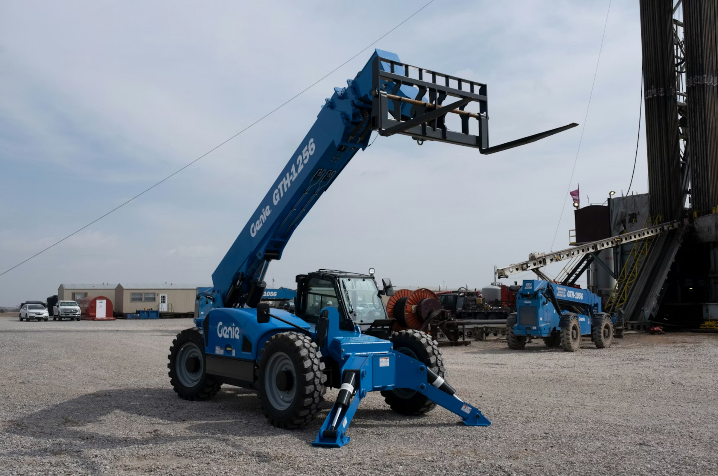 Rugged automotive tire and wheel on a 12K REACH telehandler for construction and roofing projects.