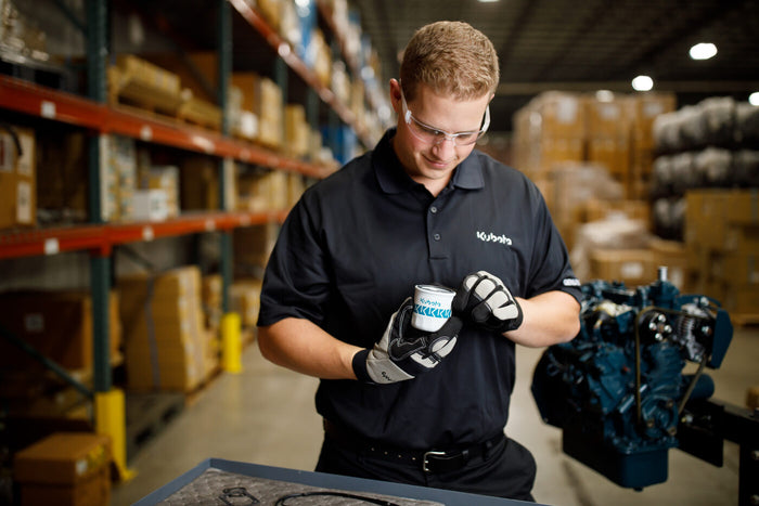 Alpine technician servicing a Kubota industrial engine at the American Fork shop